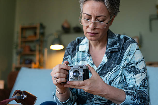 Mature woman is holding a camera