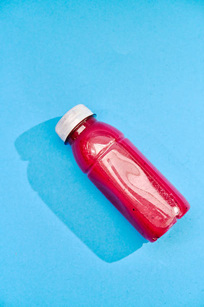 Red Berry Smoothie in Recycled PET Plastic Bottle on Vibrant Background