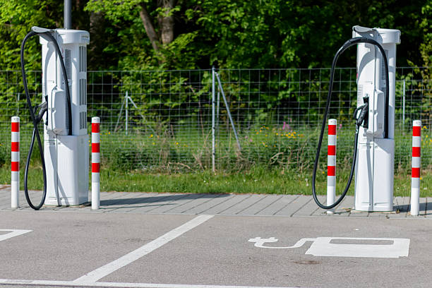 istock Electric vehicle charging stations located in outdoor setting surrounded by greenery 2215084168