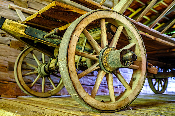 An old western wagon and broken wagon wheels.