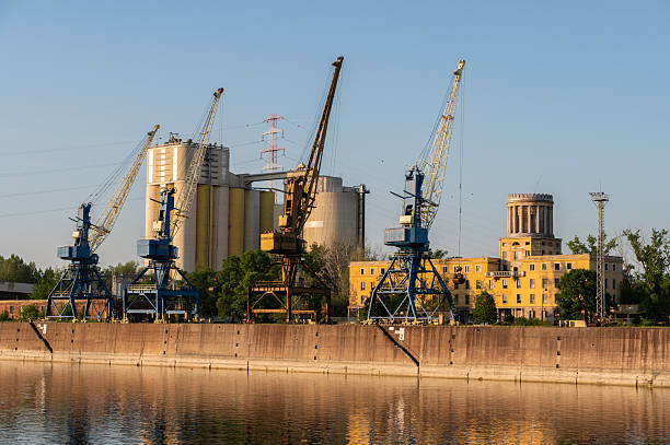 istock Riverside industrial port with cranes and silos 2215085428