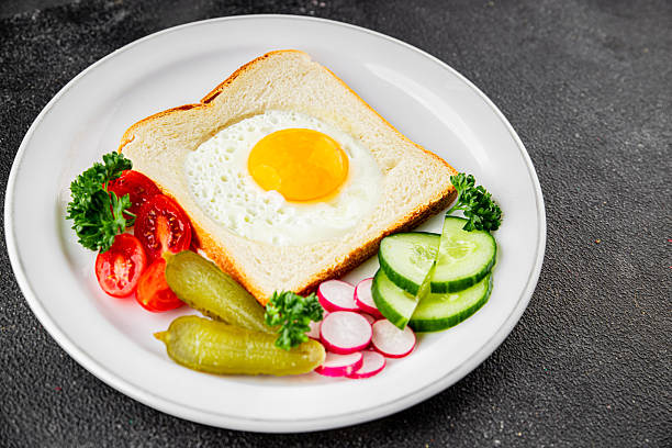 Fried gashouse eggs in bread egg in the basket delicious snack breakfast in a bowl fresh delicious gourmet food background on the table rustic food top view copy space