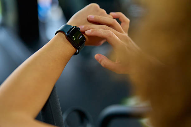 Athlete checking performance on smartwatch during workout at the gym