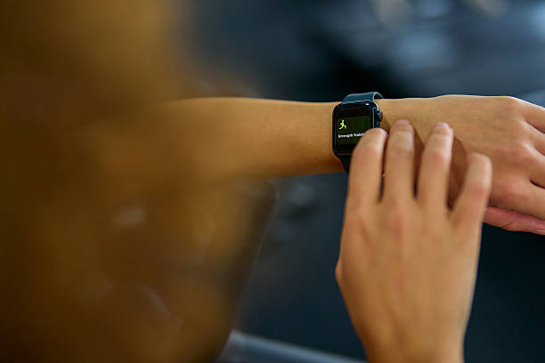 istock Woman using smartwatch during strength training at the gym 2215088773