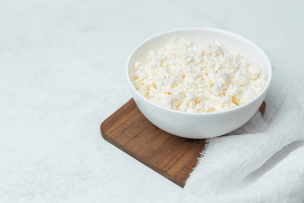 istock Freshly prepared bowl of popcorn on wooden board in kitchen setting 2215088809