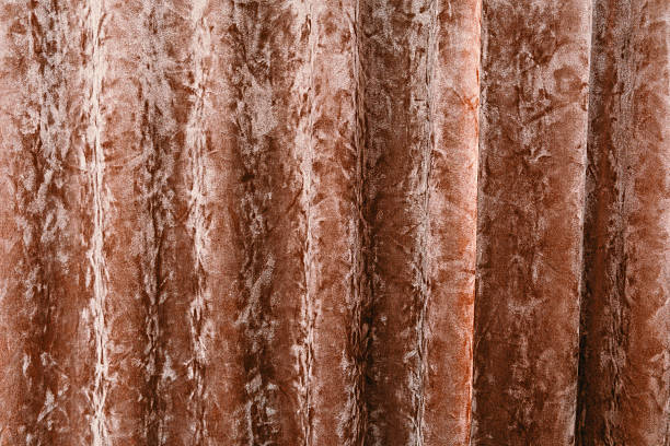istock Soft fabric curtain draping quietly in warm indoor lighting 2215088840