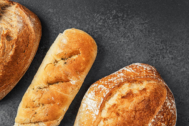 istock Freshly baked artisan bread varieties displayed on dark surface 2215088934