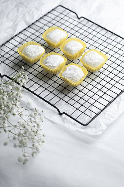 istock Deliciously sweet desserts cooling on a wire rack with delicate flowers 2215088963