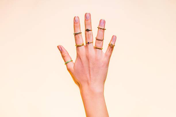 istock Hand adorned with stylish rings on a beige background. 2215090322