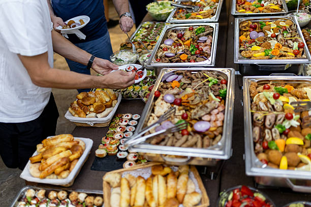 istock Buffet spread featuring a variety of dishes and guests enjoying a communal dining experience in a casual setting 2215091297