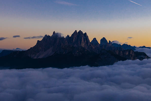 istock Above the clouds Dolomites rocky peaks. Towering cliffs above the clouds 2215091366