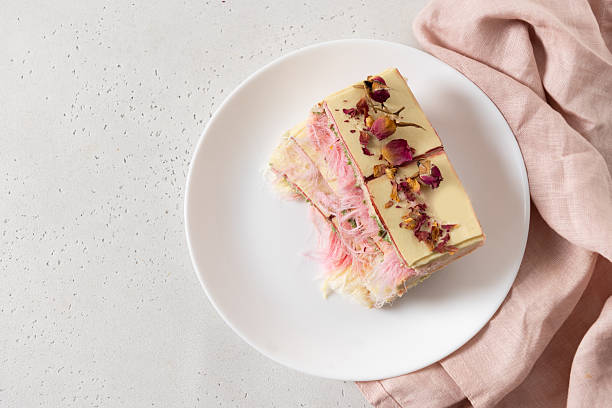 istock Trendy pink chocolate with airy filling on marble board. 2215091437