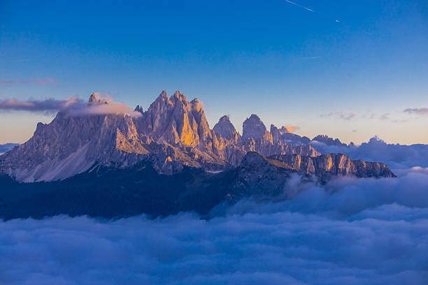 istock Above the clouds Dolomites rocky peaks. Towering cliffs above the clouds 2215091541