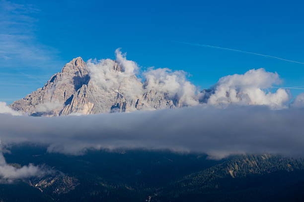 istock Above the clouds Dolomites rocky peaks. Towering cliffs above the clouds 2215091678