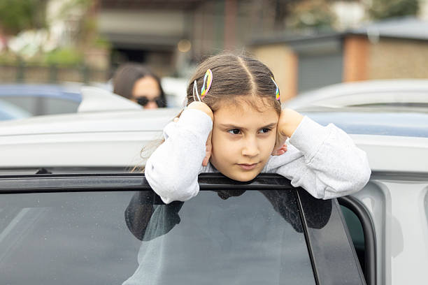 istock A girl making a funny pose on the car 2215091785