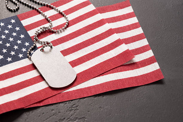 istock Military ID Dog Tag Hanging with American Flags on black background 2215091925