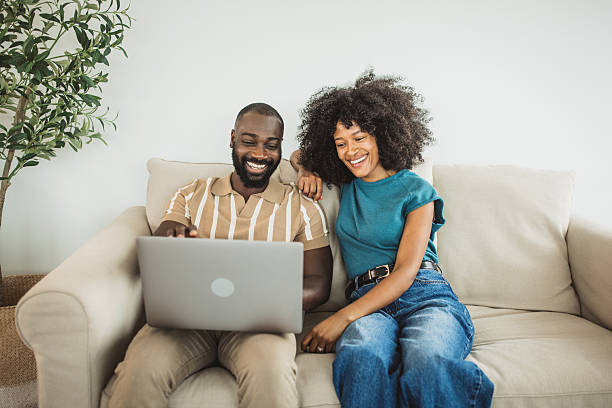 istock Happy black couple relaxing at home 2215093406