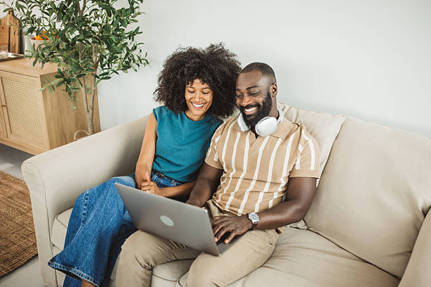 istock Happy black couple relaxing at home 2215093439