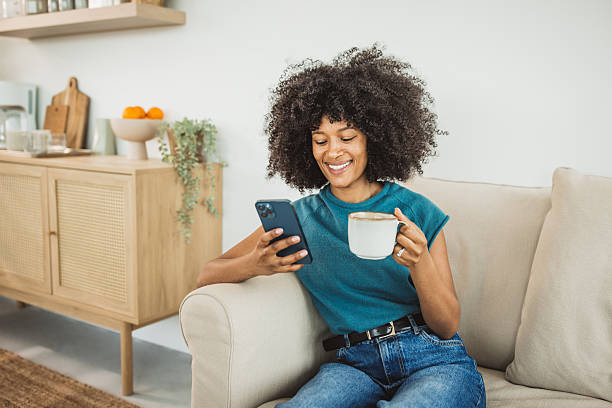 istock Woman relaxing on sofa and using smart phone 2215093506