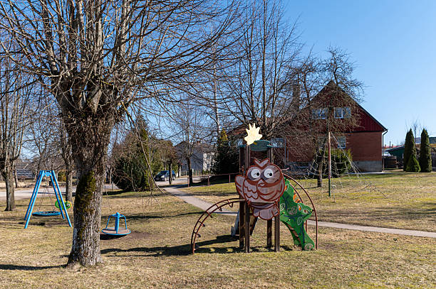 Brightly colored owl playground structure brings joy to children in a sunny park.
