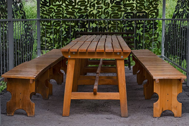 metal bench seat and a bird bath  in a backyard