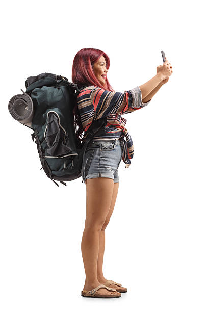 istock Asian tourist with a backpack taking a selfie with a smartphone 2215095149