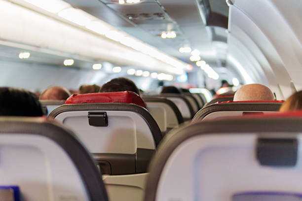 istock Passengers sitting in seats on a commercial airplane flight 2215095414