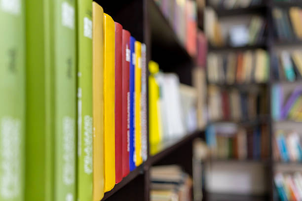 Various types of books on a library shelf. Education