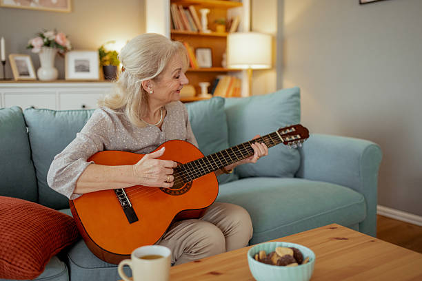 istock Senior Woman Enjoying Her Passion for Guitar in a Relaxed Setting 2215099466