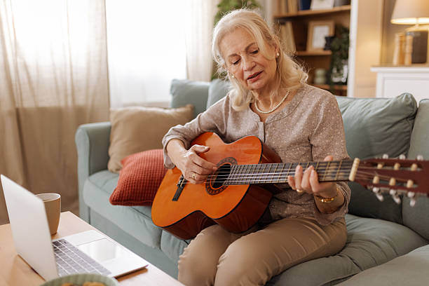 istock Senior Lady Enjoying Music and Technology in Comfortable Setting 2215099487