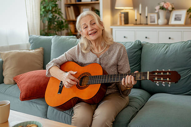 istock Senior Woman Enjoying Her Passion for Guitar in a Relaxed Setting 2215099502