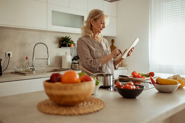 istock Older Woman Using Tablet to Find Easy and Healthy Recipes 2215099511
