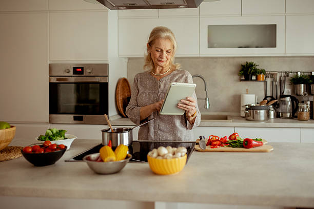 istock Older Woman Using Tablet to Find Easy and Healthy Recipes 2215099512