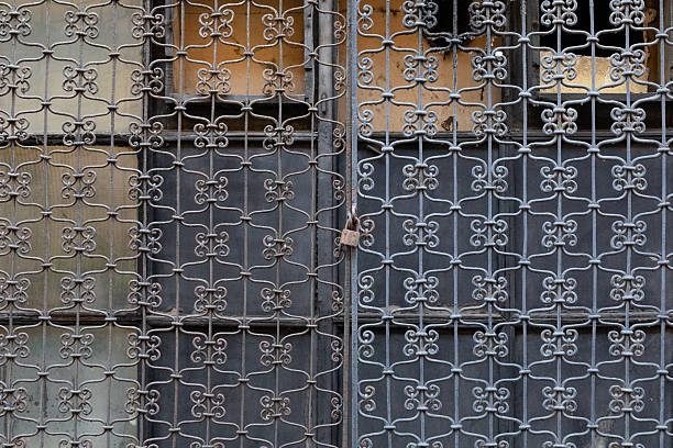 Gray wrought iron window grille with lock in Warsaw.