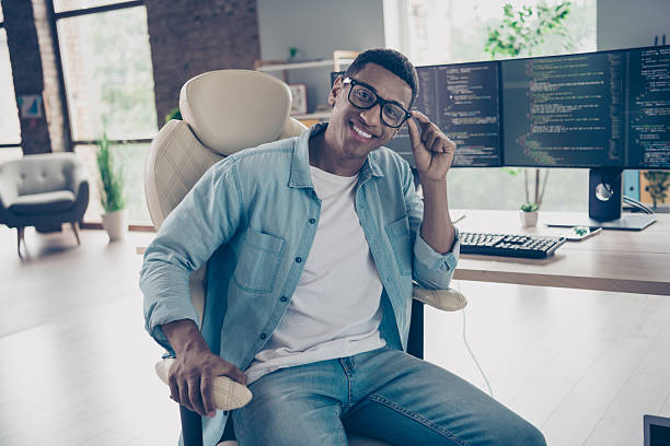 istock Portrait of cheerful skilled glad man junior dev ops engineer programmer in big company looking camera sitting armchair indoors office 2215109875