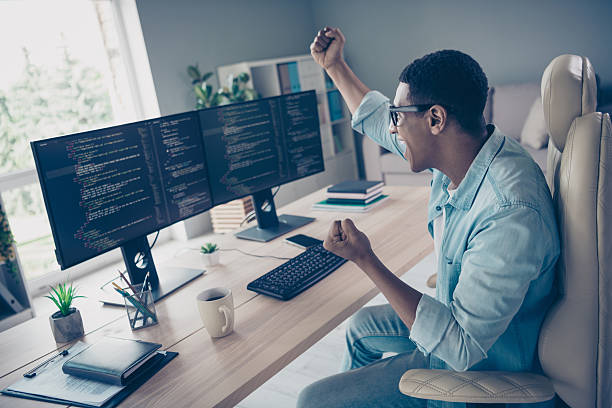 istock Side shot of crazy young guy celebrating his code works without bugs he raised fists up hooray software developer in office workspace 2215110917