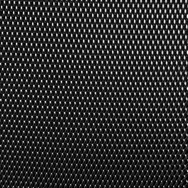 Black geometric pattern background of carbon fiber texture. Dark micro dot pattern and shiny reflective surface. Concept of texture, detail and high quality material
