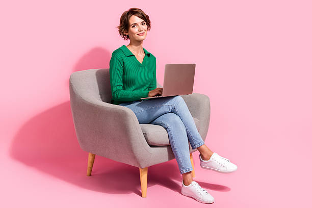 istock Full length photo of young programmer girl using digital computer browsing internet and analyzing bugs isolated on pink color background 2215112328