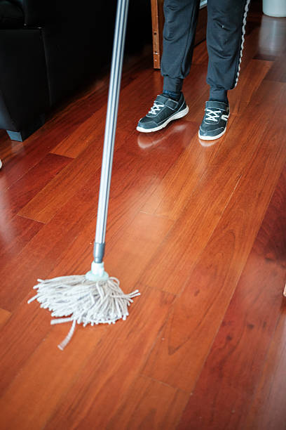 istock Cleaning hardwood floor with a mop 2215116422