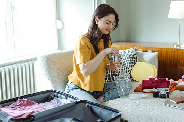 istock Young woman packing and preparing for a trip 2215119445