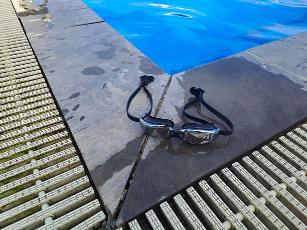 istock A swimmers goggles placed beside a pools edge 2215120626