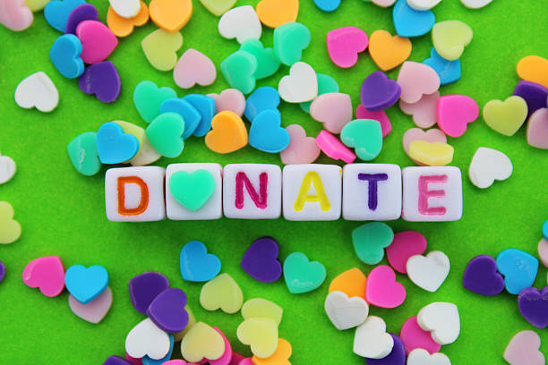 istock Cubes with the word donate surrounded by colorful hearts 2215128379