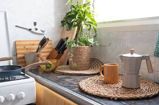 Steaming coffee filling a cozy mug rests beside a moka pot on a kitchen counter, inviting moments of relaxation during the busy morning routine and breakfast preparation