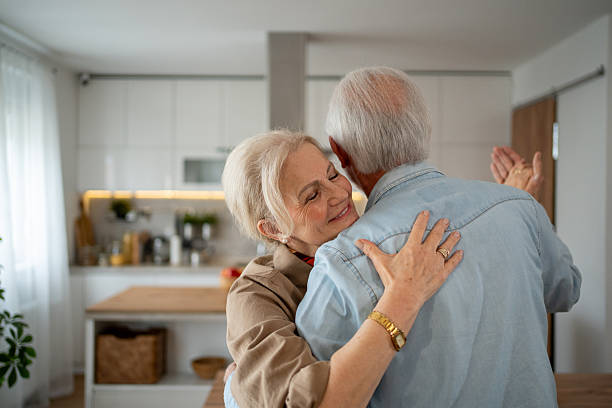 istock Happy senior couple dancing together in their kitchen 2215128592