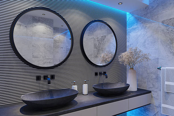 istock Modern Luxury Bathroom with Double Black Stone Sinks and Wood Accent Wall and Blue LED lights 2215129206