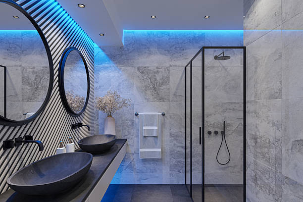 istock Modern Luxury Bathroom with Double Black Stone Sinks and Wood Accent Wall and Blue LED lights 2215129213