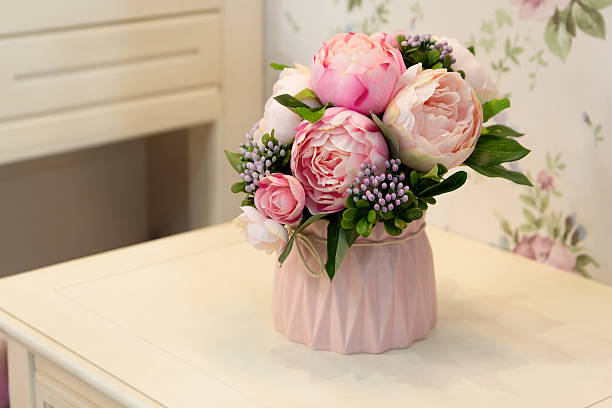 istock Decoration artificial peonies flower in the vase on the table 2215130247