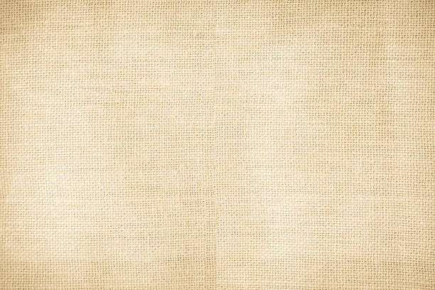 istock Brown sackcloth woven texture background in natural pattern. Jute hessian burlap, linen background in light beige cream color blank. Weaving canvas fiber line cotton cloth textured as organic. 2215131747