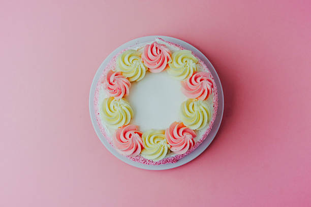 istock Colorful cake decorated with swirls on a pastel background 2215132449