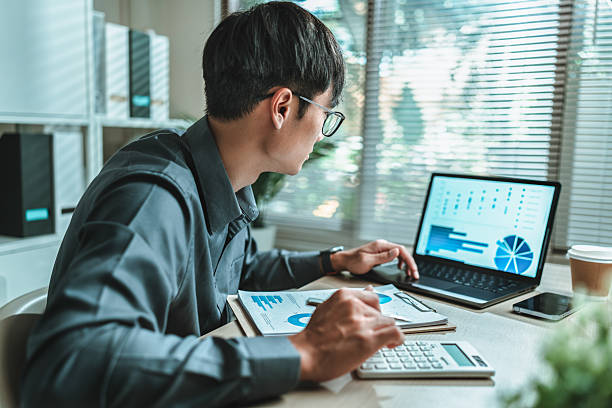 istock Accountant wearing glasses sitting and working on laptop. This involves various accounting and financial concepts. 2215142447
